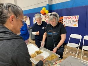 Altrusa Volunteers serving early Thanksgiving at Boys & Girls Club 